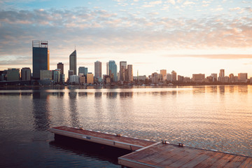 Fototapeta na wymiar The Perth city skyline at sunrise. Iconic skyline with magical golden light behind it. 