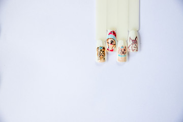 Christmas Nail art manicure. Winter Holiday style bright Manicure with gems Christmas tree and snowflakes. Bottle of Nail Polish. Manicure Design. Christmas decorations.Copy space