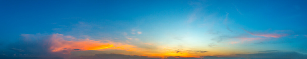 Panorama Sunlight with dramatic sky. Cumulus sunset clouds with sun setting down on dark background.Vivid orange cloud sky.