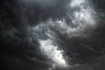 Fototapeta premium Dark sky and dramatic black cloud before rain.A tropical cyclone is a rapidly rotating storm system characterized by a low-pressure center, a closed low-level atmospheric circulation, strong winds.