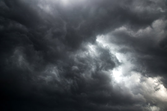 Dark sky and dramatic black cloud before rain.A tropical cyclone is a rapidly rotating storm system characterized by a low-pressure center, a closed low-level atmospheric circulation, strong winds.