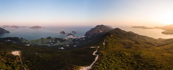 Aerial view of the sunset over the famous Dragon's back hiking trail and the Shek O village in the wild south part of Hong Kong island - obrazy, fototapety, plakaty