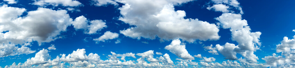 Naklejka na ściany i meble Panorama Sunlight with blue sky on dark background.Vivid sky on white cloud.