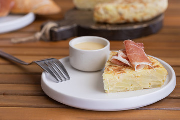 Tortilla Spanish omelette served with traditional jamon and bread. Spanish cuisine background. 