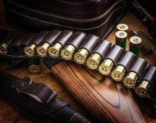 Pump action shotgun, 12 mm hunting cartridge  and hunting knife.