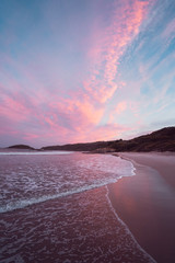 Fototapeta premium Epic pink and purple sunset over Cosy Corner Beach in Albany, Western Australia. Beautiful vibrant colours in the sky over the beach. 