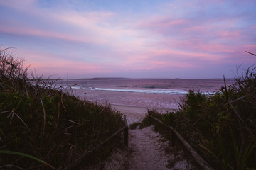 Epic pink and purple sunset over Cosy Corner Beach in Albany, Western Australia. Beautiful vibrant colours in the sky over the beach. 