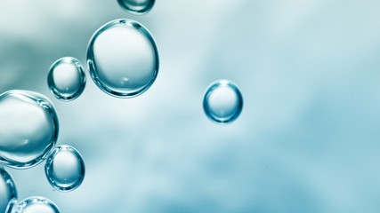 transparent gas bubbles on water surface. Worms-eye low angle with crystal bubbles in purified water on blue background. cosmetic background with copy space