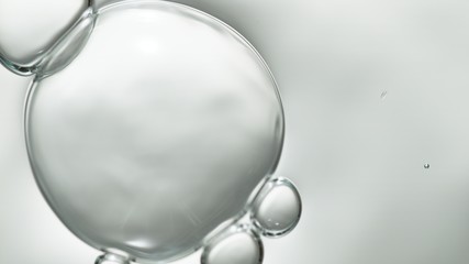 transparent gas bubbles on water surface. Worms-eye low angle with crystal bubbles in purified water on white background. cosmetic backdrop with copy space
