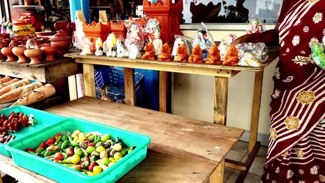 Terracotta toys  display on a gallery bench on the road side shop.