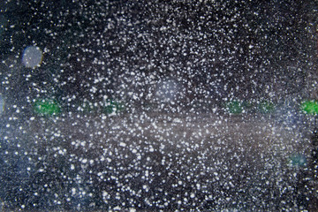 Naklejka na ściany i meble Abstract dust explosion and flash with illumination on a black background