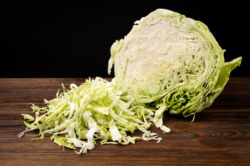 Fresh cabbage on dark wooden background.