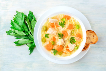 Chicken noodle soup, shot from the top with toasted bread