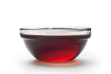 Bowl of sesame oil isolated on white background.