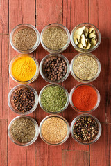 Various kinds of colourful seasonings in bowls. Collection of spices