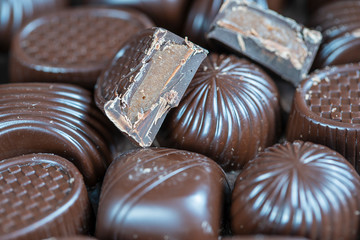 Brown chocolate candy background. Assortment of chocolate candies sweets
