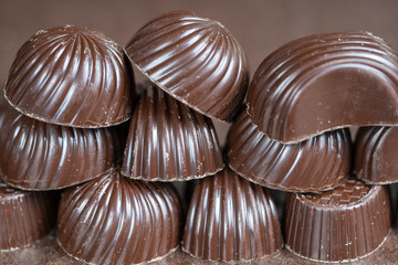 Brown chocolate candy background. Assortment of chocolate candies sweets