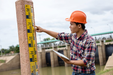 Young engineer working on site at the dam