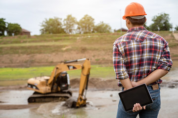 Young engineer working on site at the dam