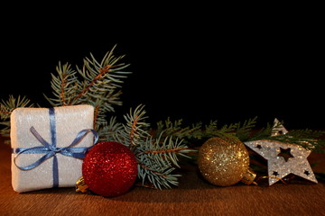 beautiful Christmas photo with twigs of spruce, Christmas toys on the background of falling snow