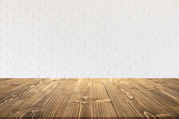 Empty wooden board or table with abstract blurred white brick wall background