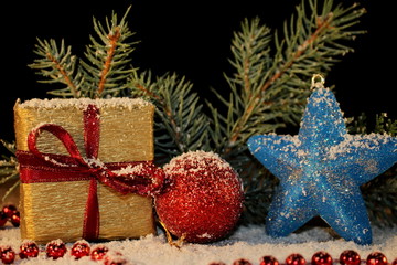 beautiful Christmas photo with twigs of spruce, Christmas toys on the background of falling snow