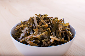 Ceramic bowl with marinated sea kale, view from above
