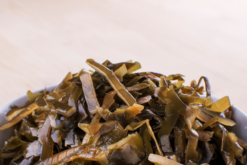 Japanese seaweed salad Chuka in wood bowl on white background. isolated on white background with clipping path.