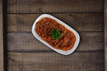 Turkish meze, acili ezme or spicy paste with bread isolated on wooden background