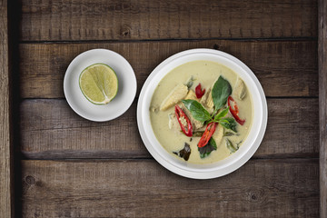 Top view Thai food chicken green curry isolated on rustic wooden table