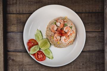 Top view Thai food shrimp fried rice isolated on rustic wooden table