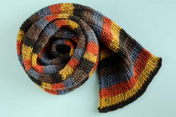 Woolen scarf composition on blue background. Flat lay.