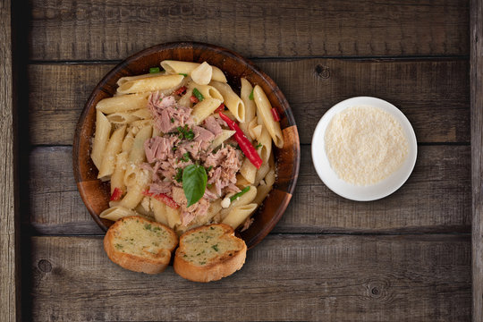 Pasta With Tuna, Garlic Bread And Parmesan Cheese Aside Isolated On Rustic Wooden Background