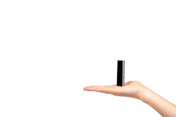 Hand with red lipstick in black tube, beauty and care.