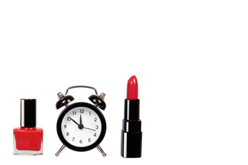 Red nail polish, lipstock and alarm clock.