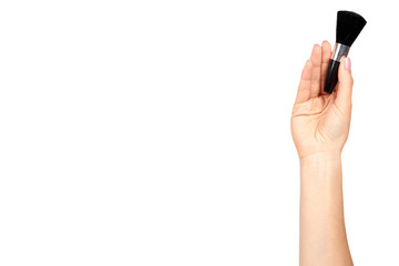 Hand with black eye makeup brush. Isolated