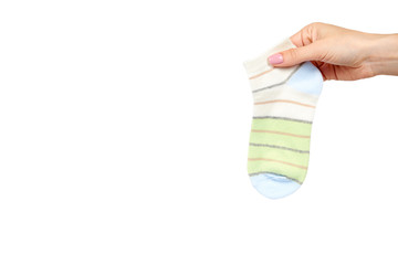 Hand with striped cotton sock, child footwear.