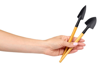 Hand with little shovel, wooden handle, decorative tools.