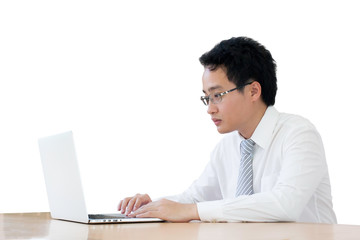Fototapeta premium Portrait of young businessman working with laptop on table isolated white background.