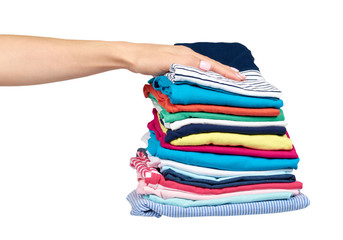 Hand with stack of clothes, fresh laundry textile. Isolated.