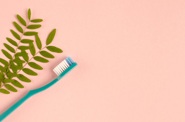 Colored toothbrushes composition on pink background. Flat lay.