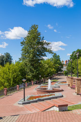Walking along the alley with a fountain on the banks of the Vitba River in the city of Vitebsk, Belarus. Perspective view.