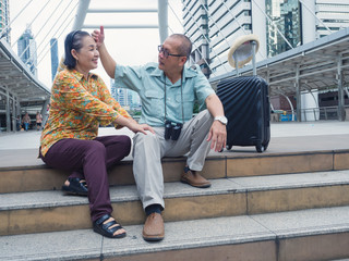 elderly couples massaging their legs while traveling in the city