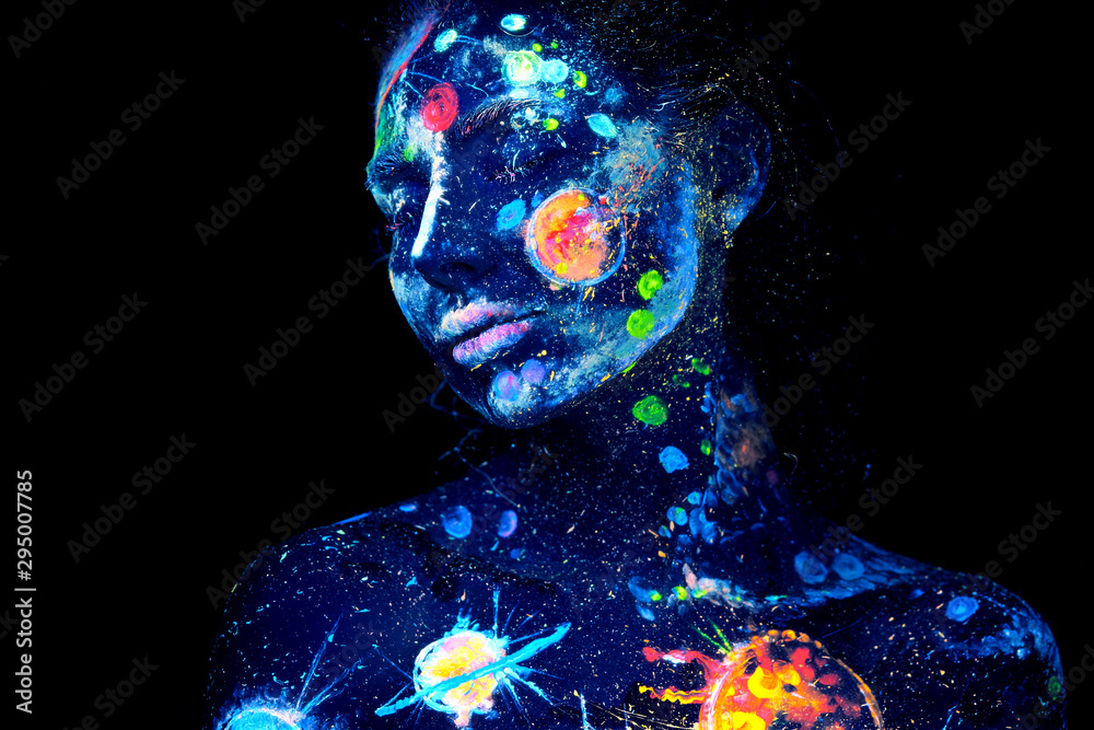 Wall mural uv painting of a universe on a female halloween body portrait