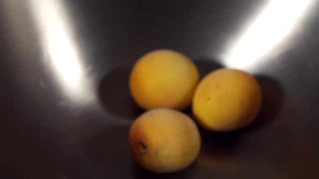 a Japanese female chef weighing Nanko-Ume plums at her home kitchen, Tokyo, Japan. July 2019. Camera fixed, extreme close-up, high view