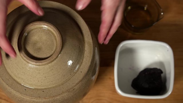 a Japanese female chef preparing UMEBOSHI at her home kitchen, Tokyo, Japan. July 2019. Camera fixed, close-up, bird's eye view