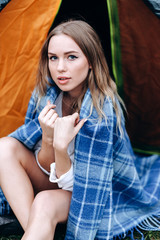 Portrait of handsome girl sitting next the tent