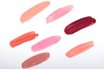 Nail polish strokes pattern background in nude pink, peach, red colors. Abstract paint blots background for beauty and fashion, copy space