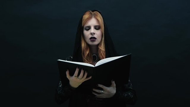 Gothic witch  reading book in slow motion