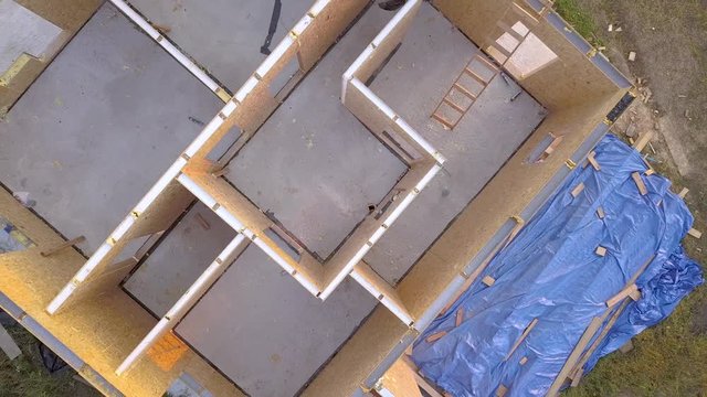 Construction of new and modern modular house. Walls made from composite wooden sip panels with styrofoam insulation inside. Building new frame of energy efficient home concept.